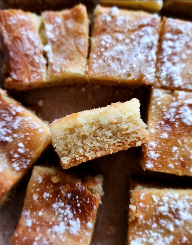 Keto gooey butter cake cut and turn for side view.