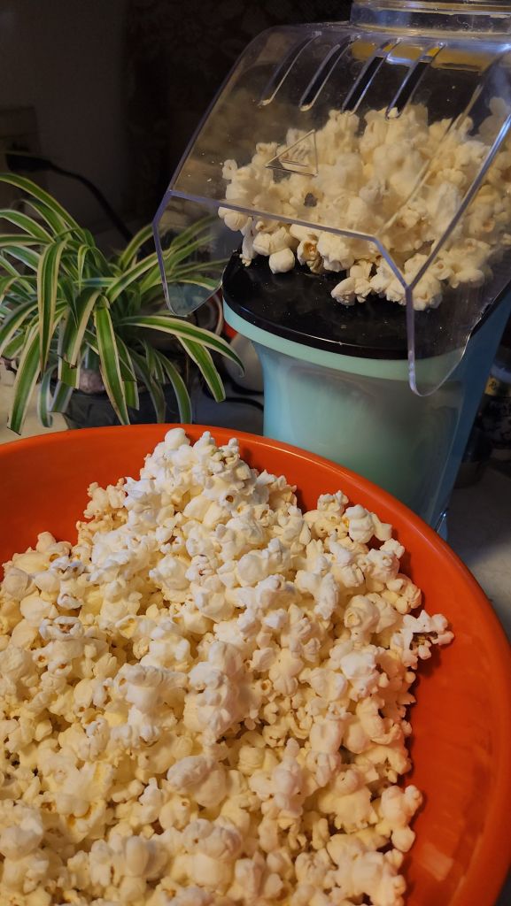 Playing popcorn being popped with an air popper.