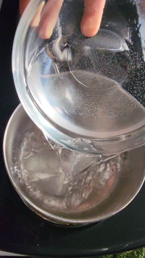 Pouring water into a saucepan.