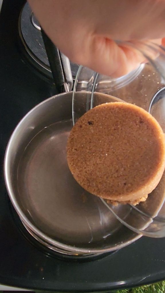 Adding keto brown sugar to water in a saucepan.