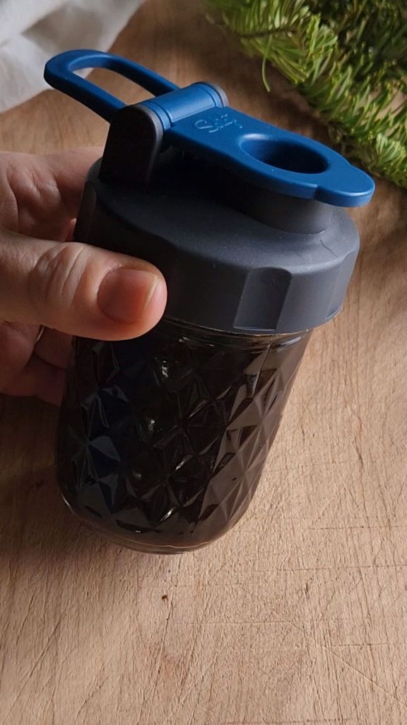 Low carb copycat Starbucks gingerbread syrup in a jar with a pour spout lid.