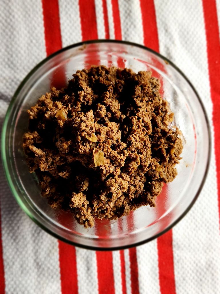 leftover taco meat in a glass bowl closeup.