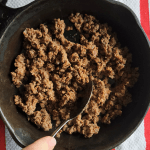reheating leftover taco meat in a skillet.