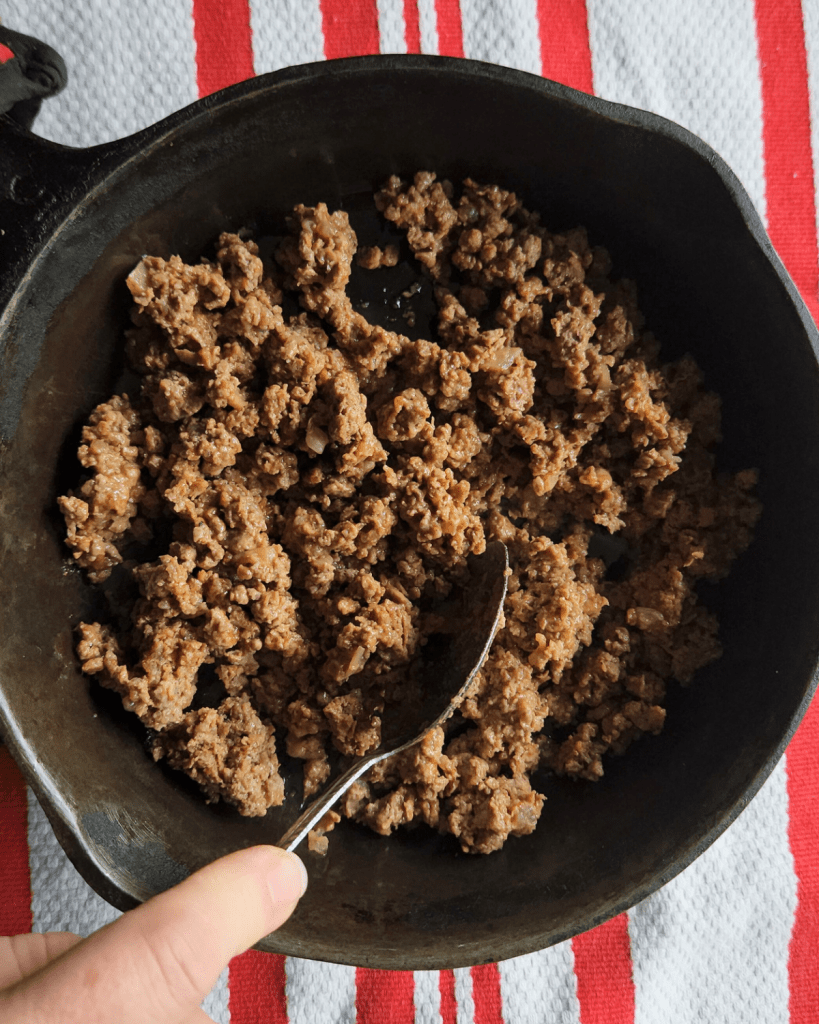 reheating leftover taco meat in a skillet.