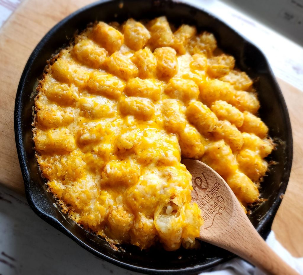 Low carb tater tot casserole in a cast iron skillet.
