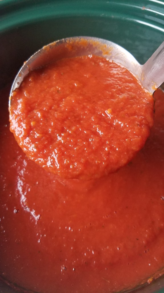 Keto marinara sauce on a ladel.