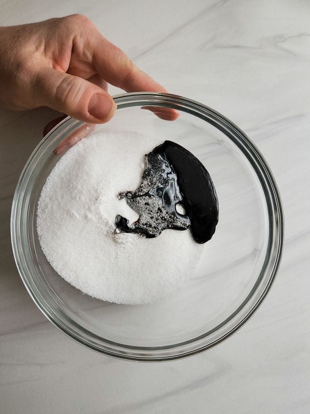 Molasses poured on top of the granulated sugar-free sweetener.