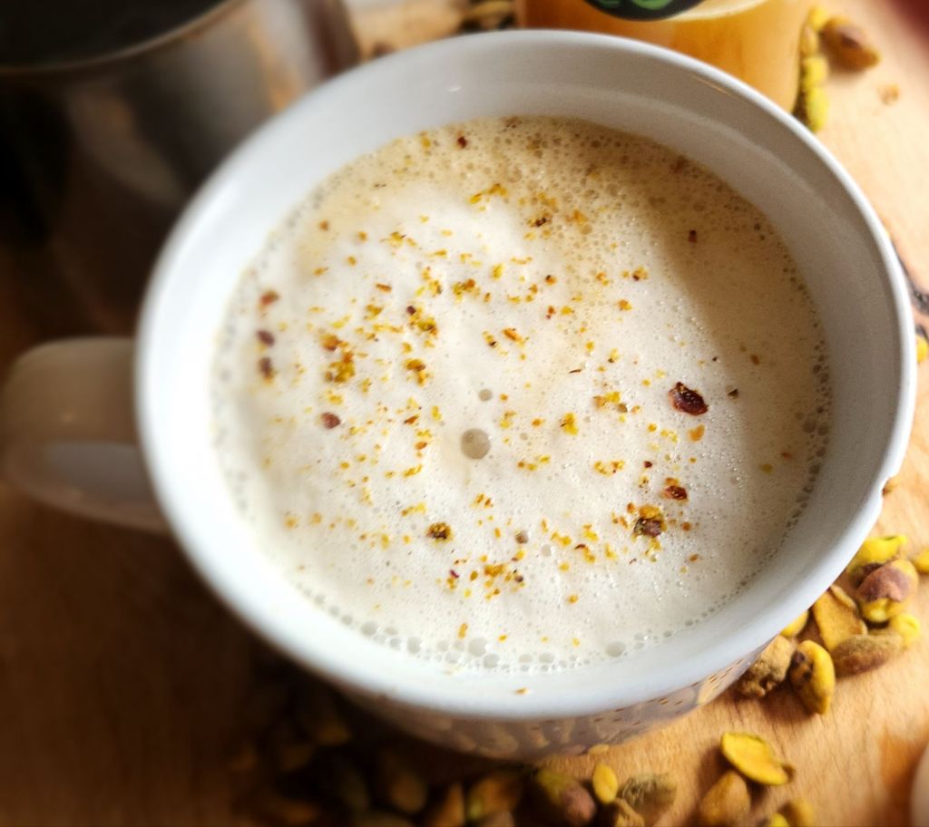 Low carb copycat Starbucks pistachio latte with foam in a large white coffee mug.
