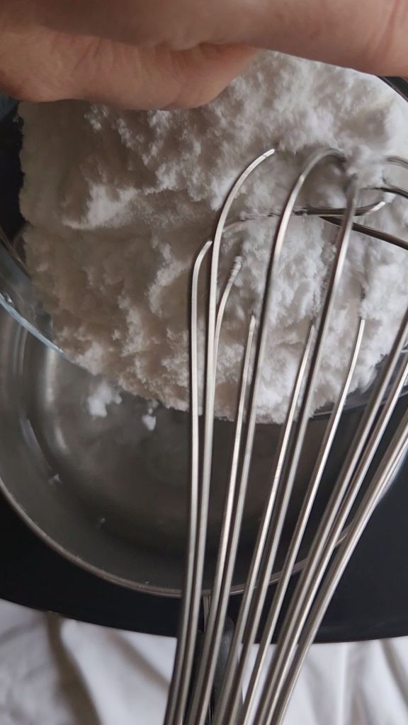 Stirring are you listen to water to make low carb copycat Starbucks pistachio latte syrup.