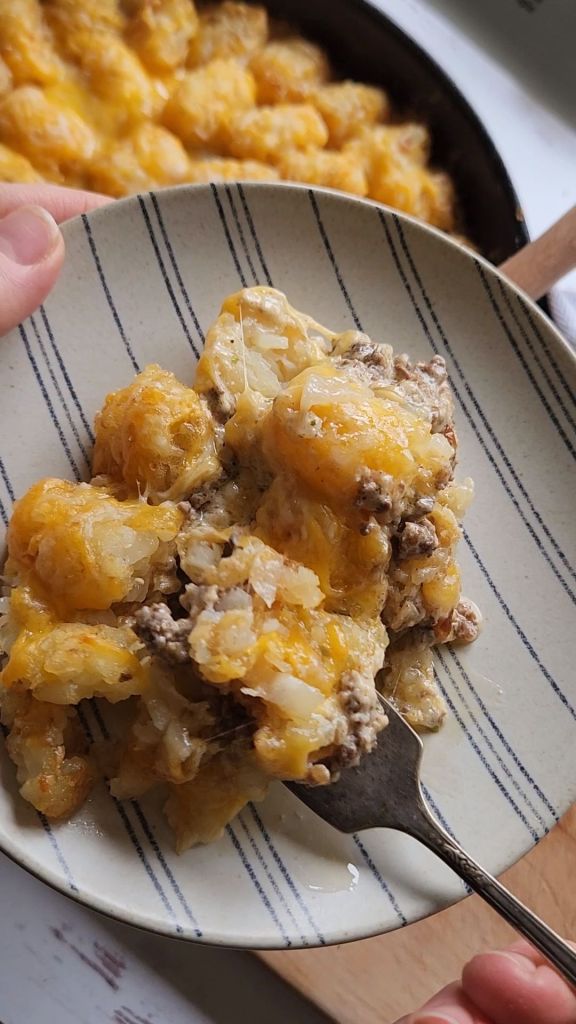 Low carb tater tot casserole served up on a small plate.