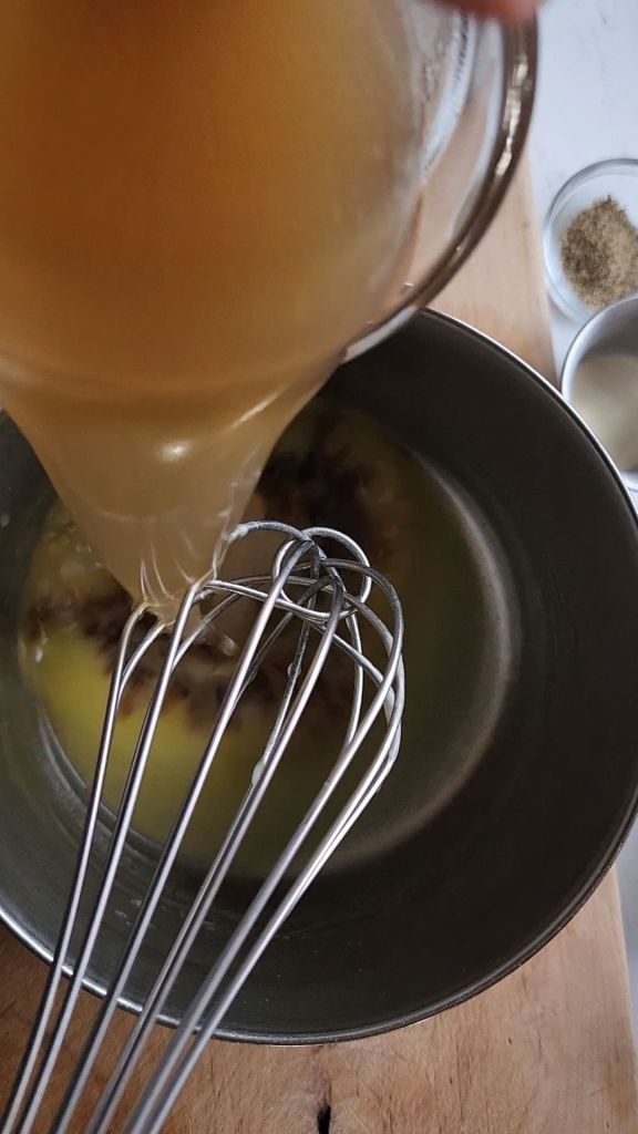 Pouring broth into saucepan.