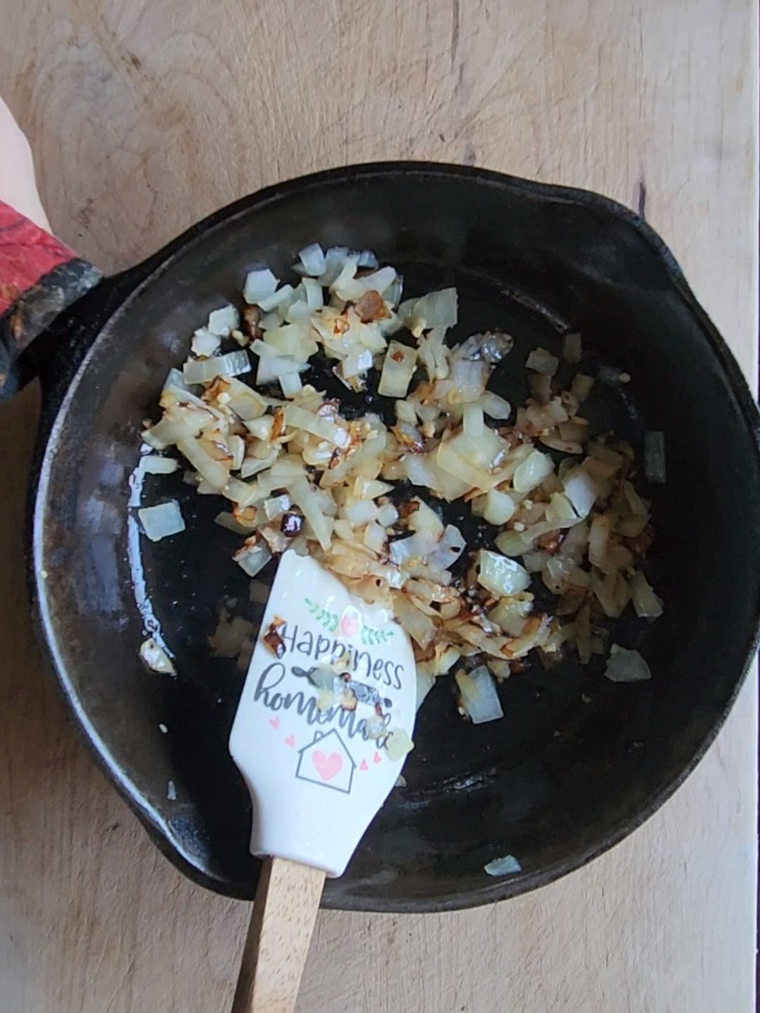 onions sauteeing in a cast iron skillet.