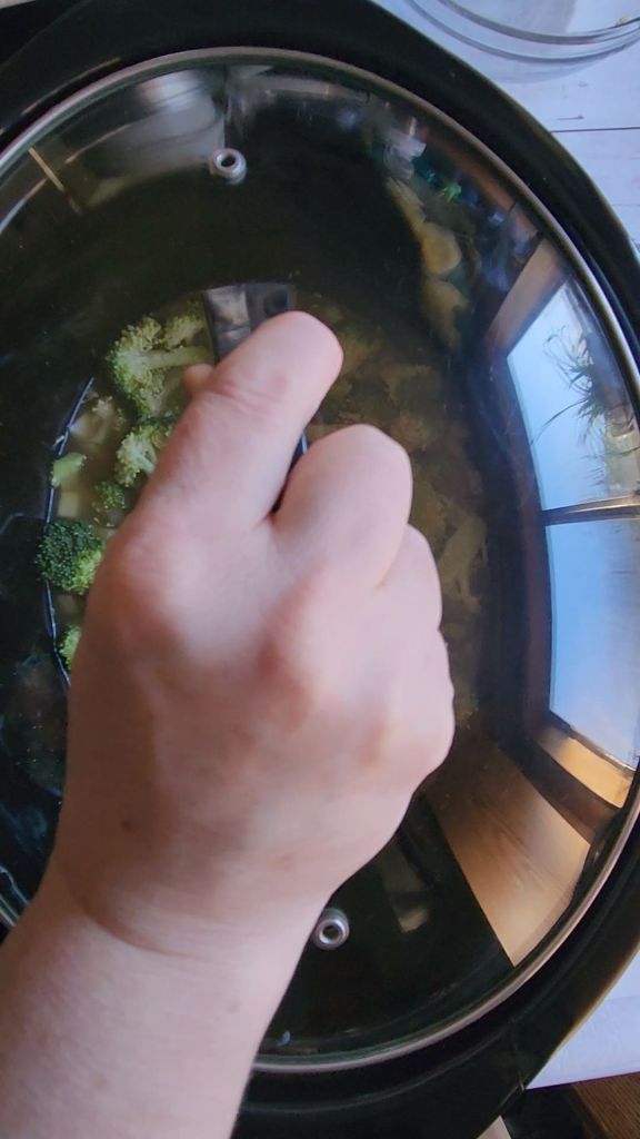 covering the crockpot with the glass lid.