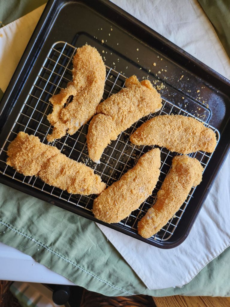 Air fryer keto chicken strips battered and ready for the air fryer.