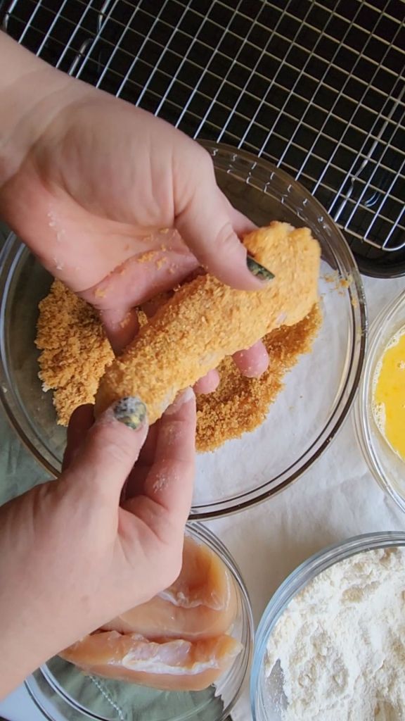 Breaded chicken tender before cooking in air fryer.