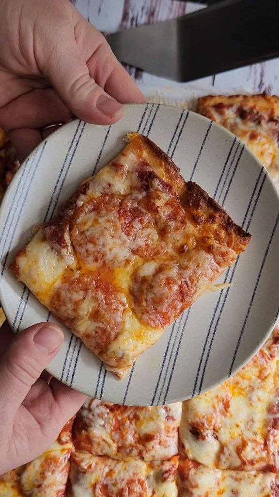 A piece of the best gluten-free keto friendly pizza on a plate.