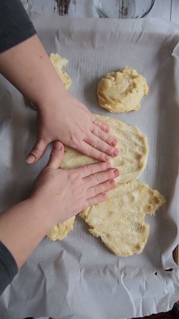 Pressing the crust out for the best gluten-free keto friendly pizza pressed out into a pan.