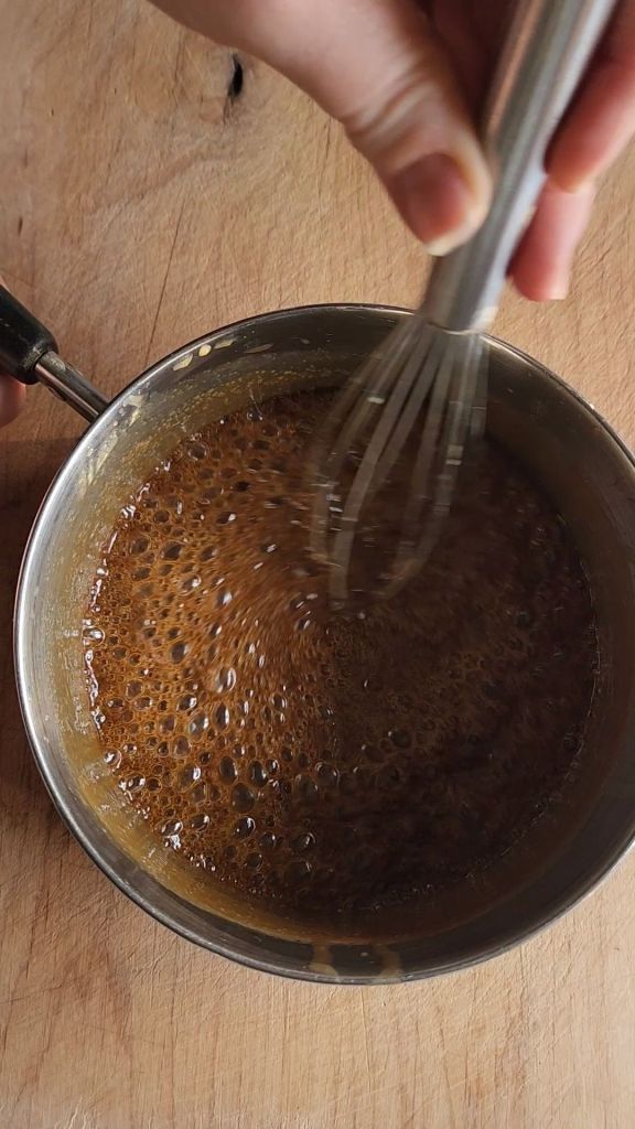 Simmering keto brown sugar and butter to make easy homemade low-carb butterscotch syrup recipe.