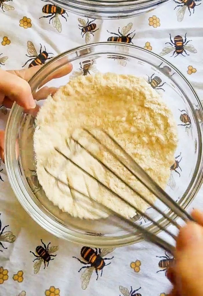 Whisking dry ingredients for Bakery style gluten-free chocolate chip muffins recipe.