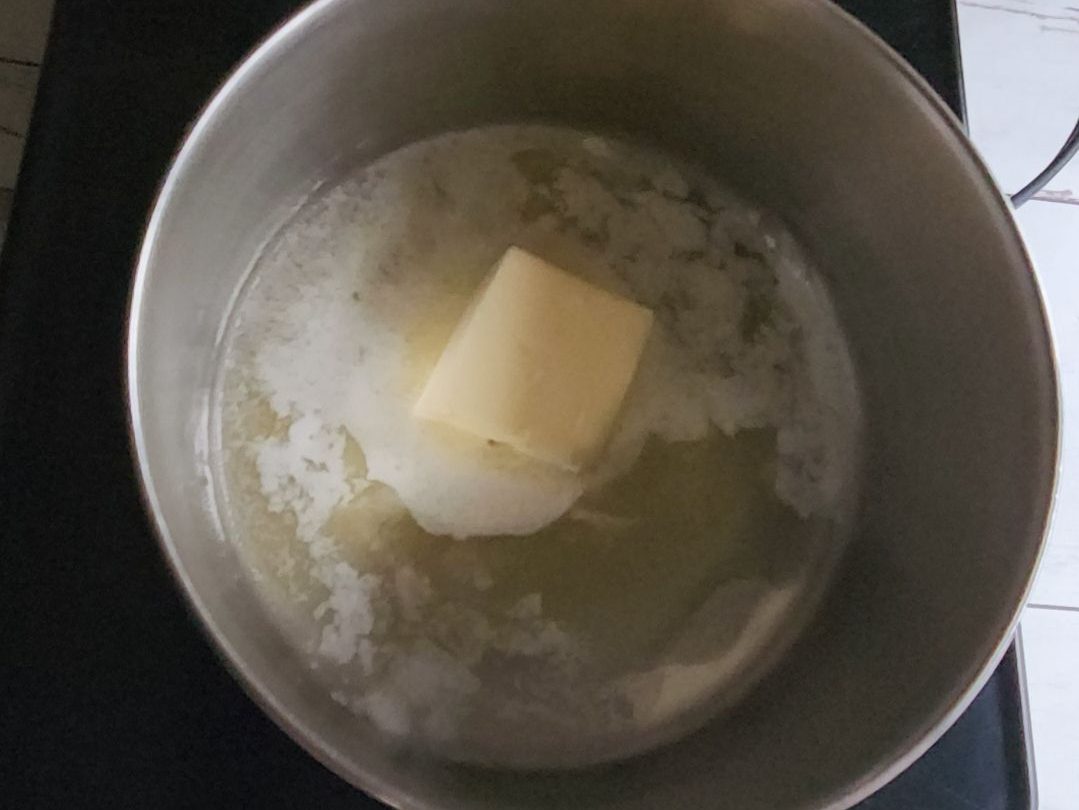 Melting butter in a saucepan to make low carb butterscotch syrup.