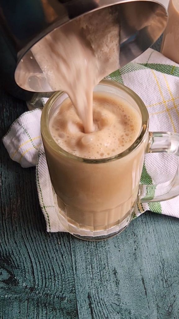 Pouring the best low carb copycat baileys Irish cream coffee creamer into a coffee drink.