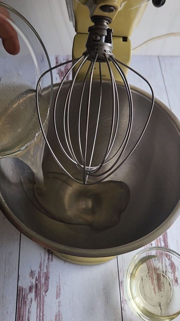 Pouring keto honey substitute into the mixing bowl.