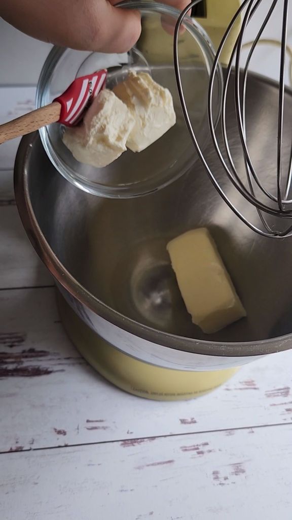 Creaming soften butter and softened cream cheese together to make sugar free strawberry frosting.