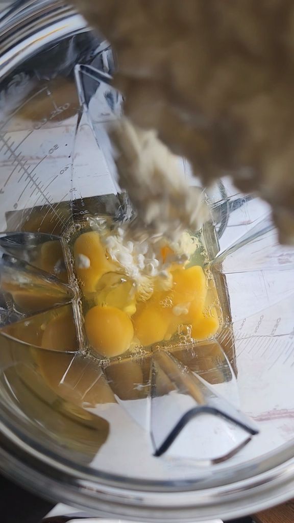 Adding cottage cheese to the blender to make gluten-free keto coffee at Starbucks egg bites.