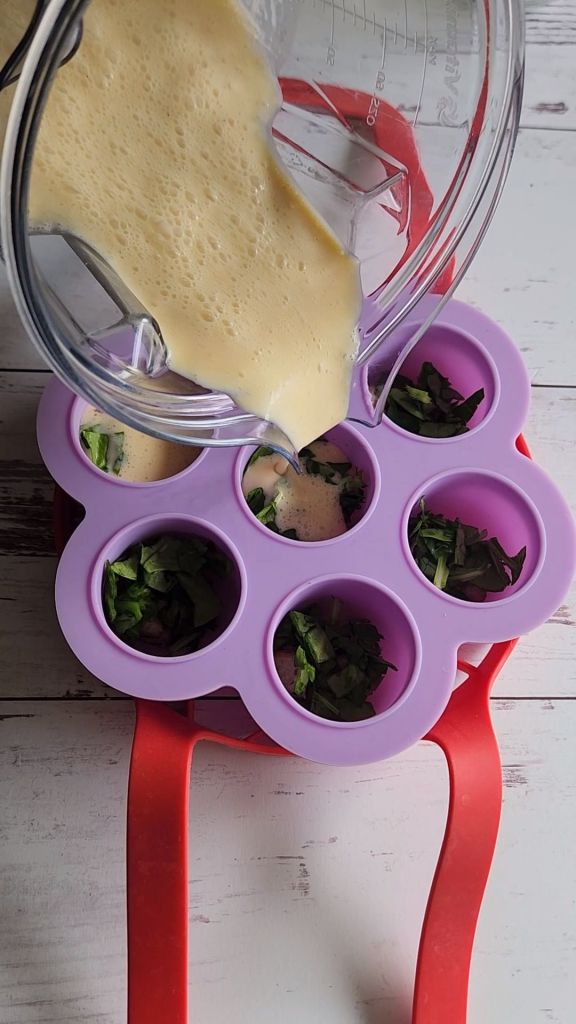 Pouring the batter for a gluten free keto copycat Starbucks egg bites into the wells.