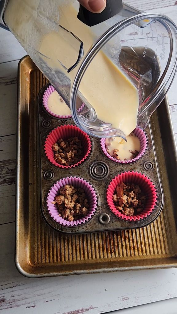Gluten-free keto copycat Starbucks egg bites in a muffin tin sitting in a pan of hot water.