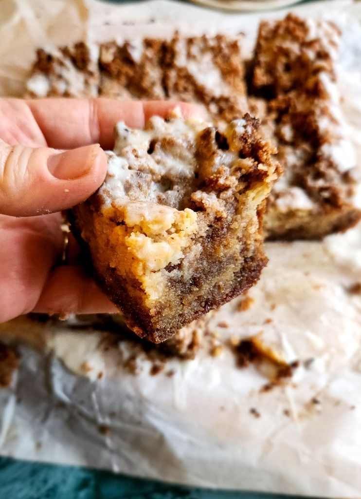 A slice of Grandma's gluten-free cinnamon coffee cake recipe being held.