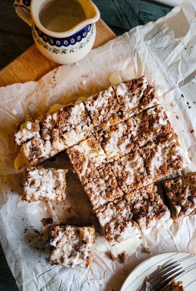 Grandma's gluten free cinnamon coffee cake recipe on parchment paper sliced into servings.