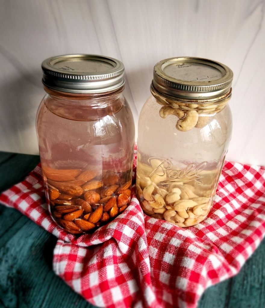 Two Glass Court jars filled with water and almonds and cashews to soak overnight.