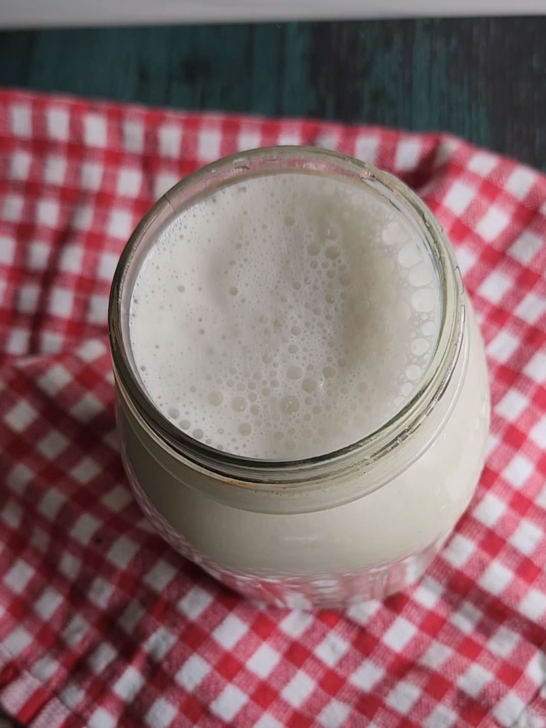 Prepared homemade cashew milk in a glass quart jar.