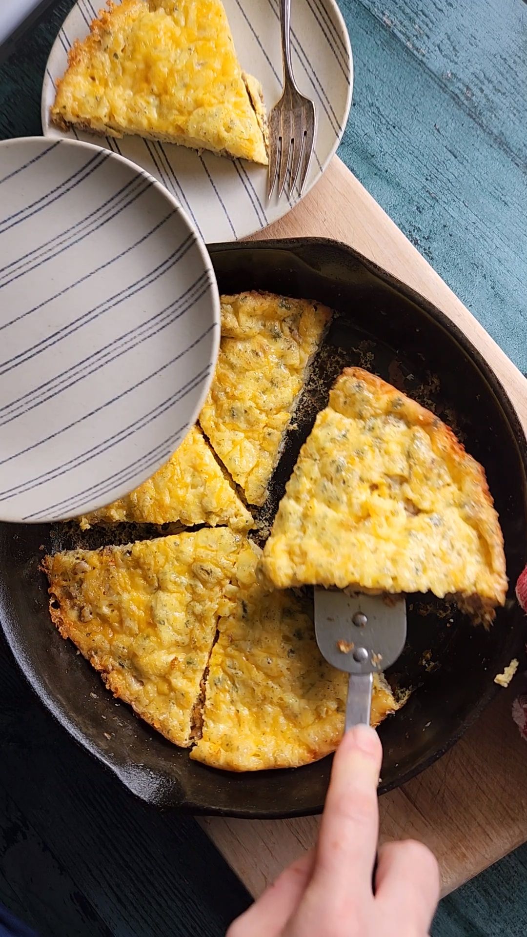 Low carb sausage and cheese frittata in a cast iron skillet fresh out of the oven from being baked.