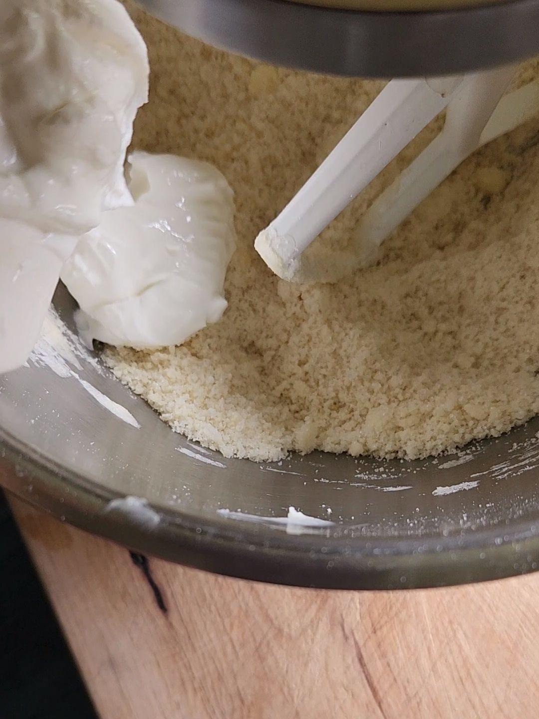 Mixing sour cream into the batter for Grandma's gluten-free cinnamon coffee cake recipe.