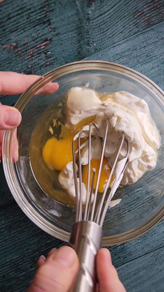 Whisking wet ingredients for egg mixture in Grandma's gluten-free cinnamon coffee cake recipe.