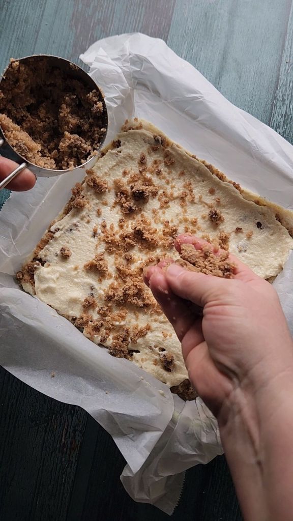 Adding second layer of strudel to the pan of Grandma's gluten free cinnamon coffee cake recipe.