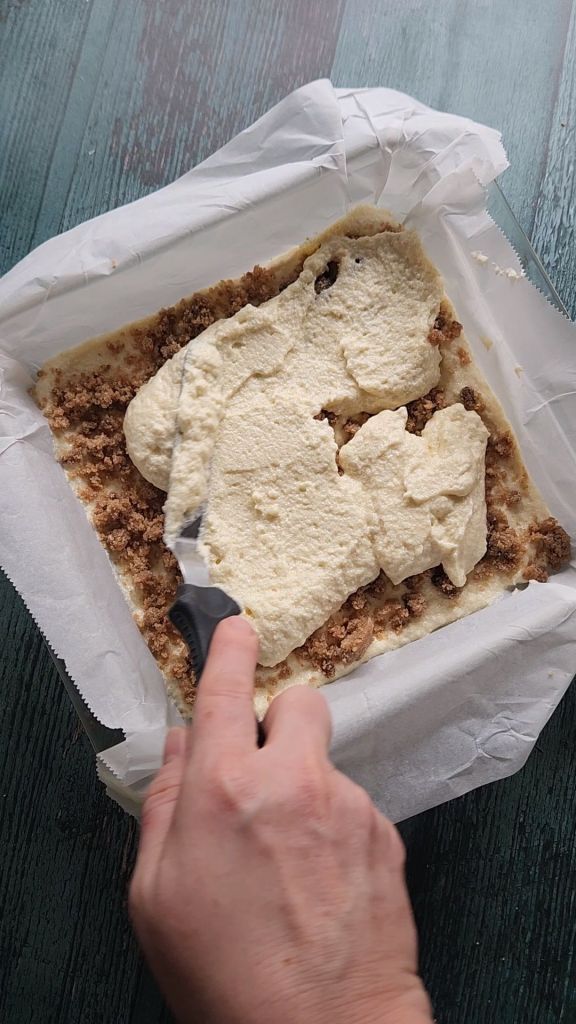 Spreading out second layer of cake batter for Grandma's gluten-free cinnamon coffee cake recipe.