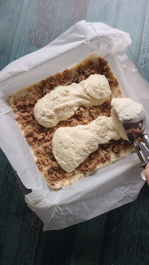 Scooping second layer of cake batter for Grandma's gluten-free cinnamon coffee cake recipe.