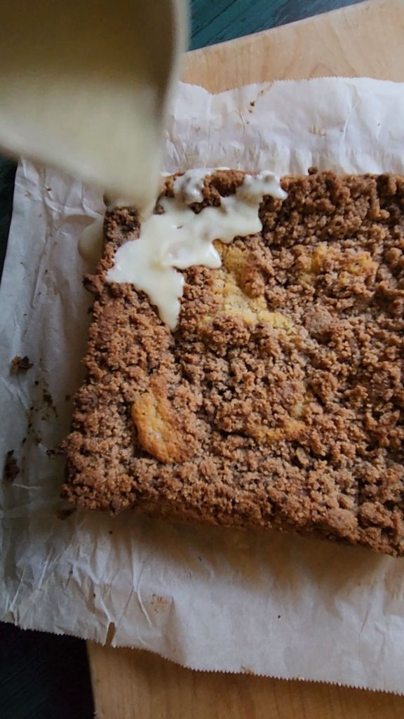 Drizzling icing on Grandma's gluten free cinnamon coffee cake.