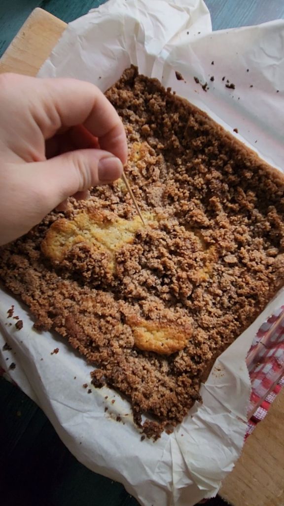 Toothpick testing baked Grandma's gluten-free cinnamon coffee cake.