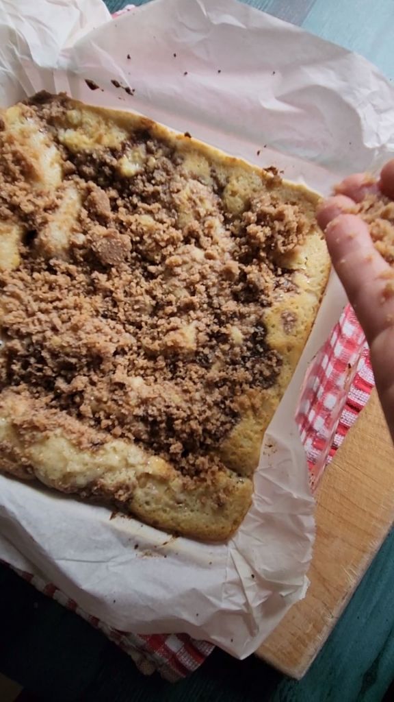 Adding the remaining streusel to the top of the Half Baked Grandma's gluten free cinnamon coffee cake.