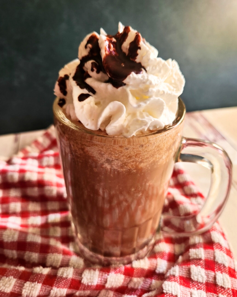 Prepared low carb copycat Starbucks caramel mocha Frappuccino topped with whipped cream and chocolate syrup.