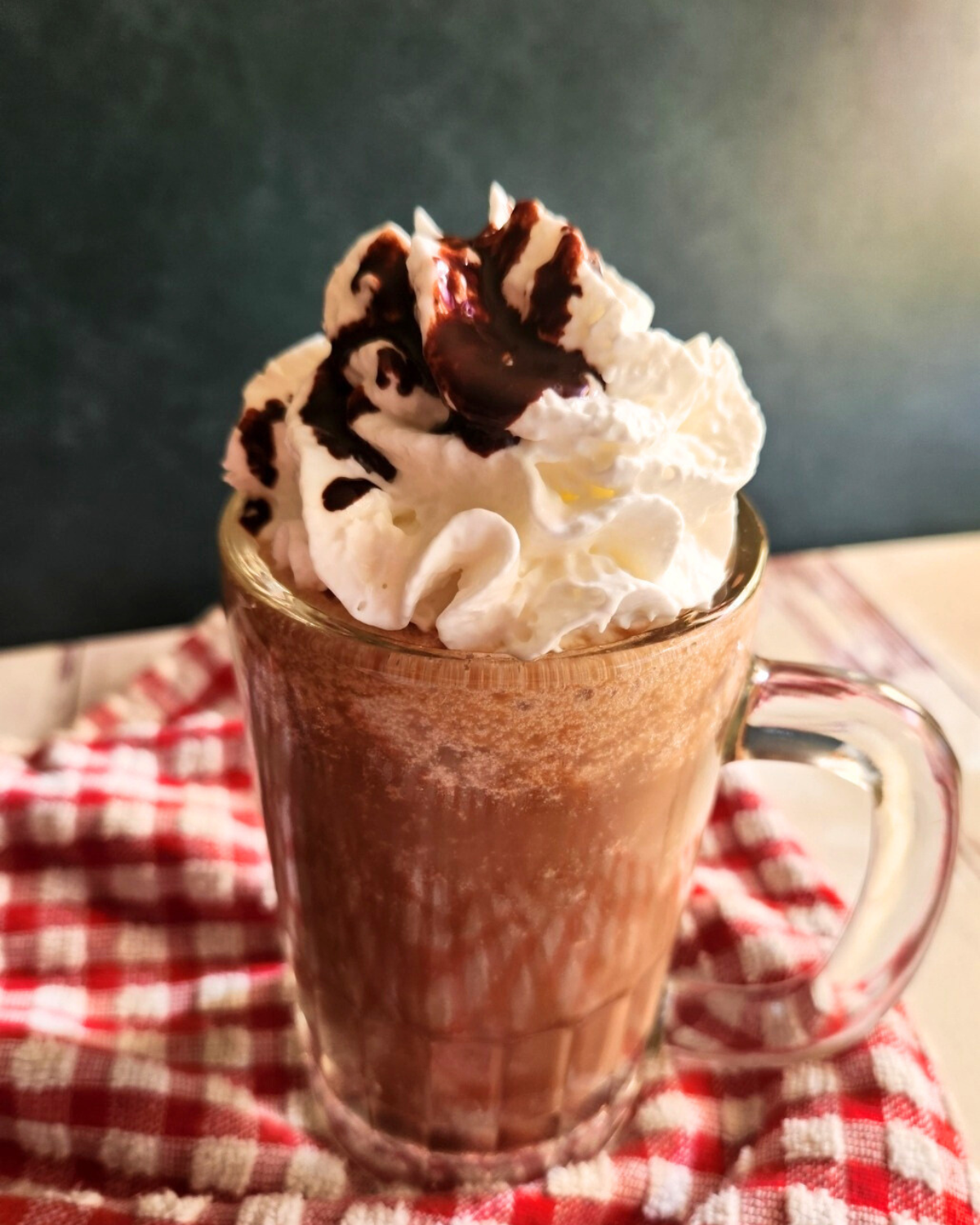 Prepared low carb copycat Starbucks caramel mocha Frappuccino topped with whipped cream and chocolate syrup.