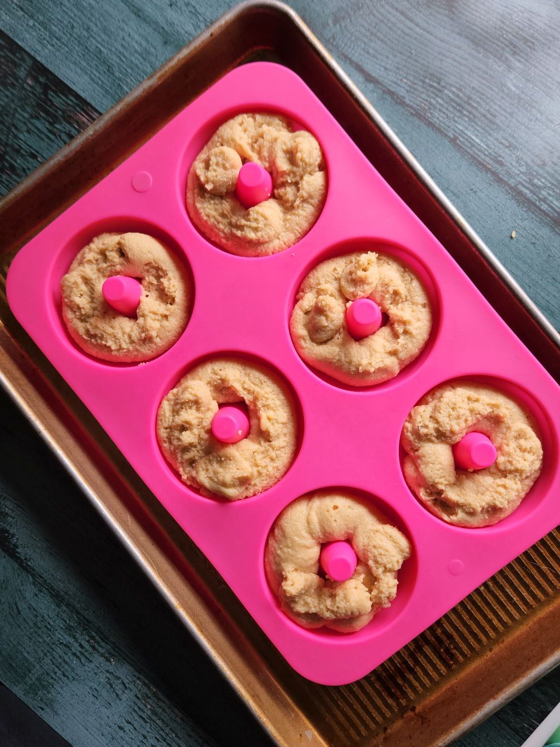 Gluten free Maple Donuts in a silicone pan ready for baking.