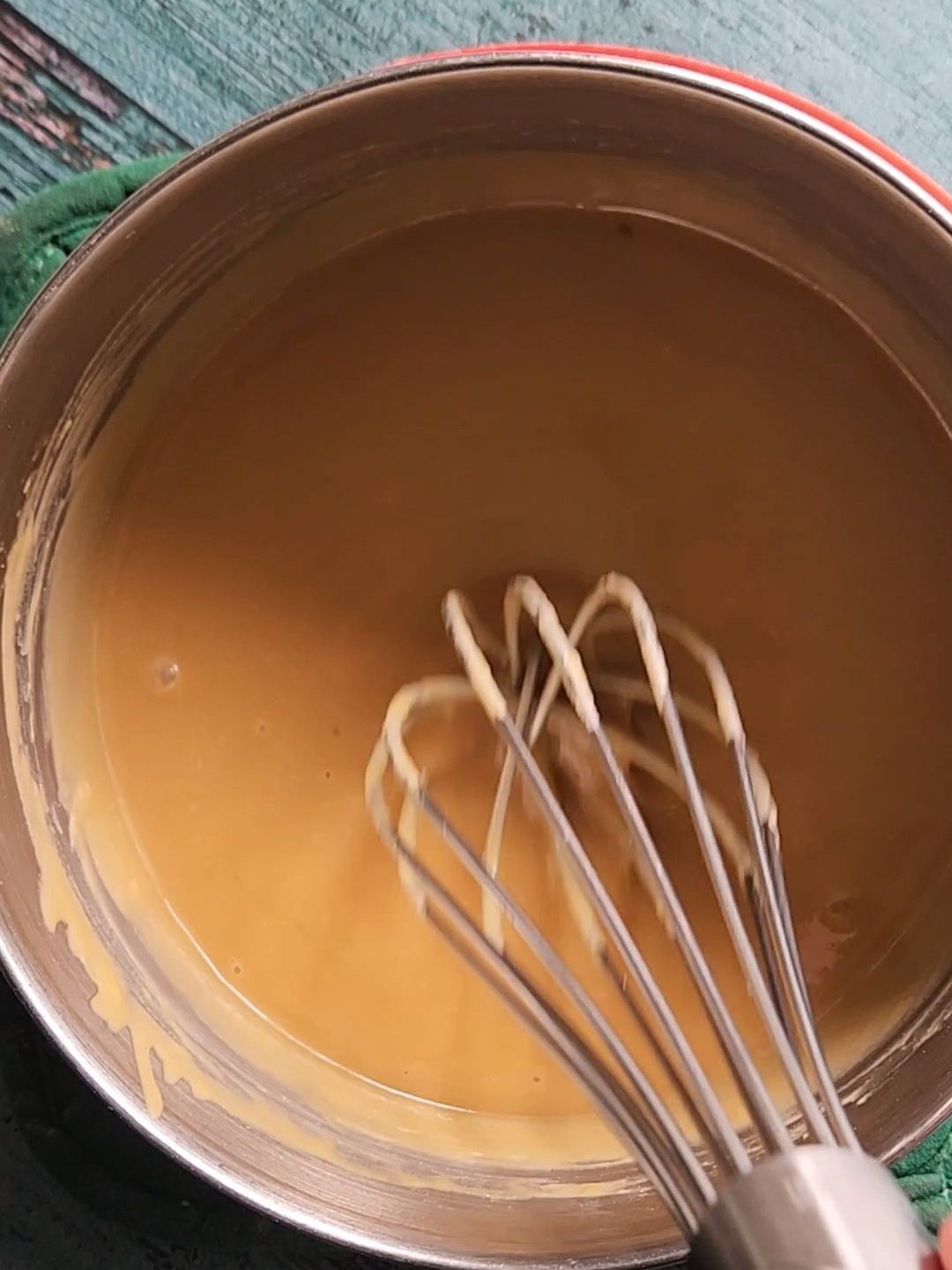 Whisking up maple glaze and a saucepan.