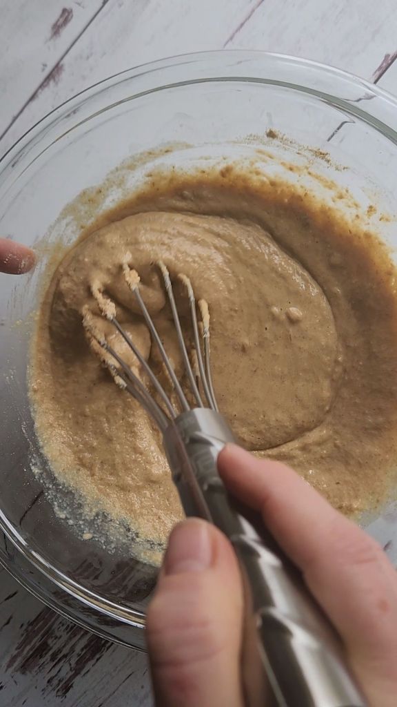 Whisking up batter for easy gluten-free fluffy baked pecan pancake recipe.