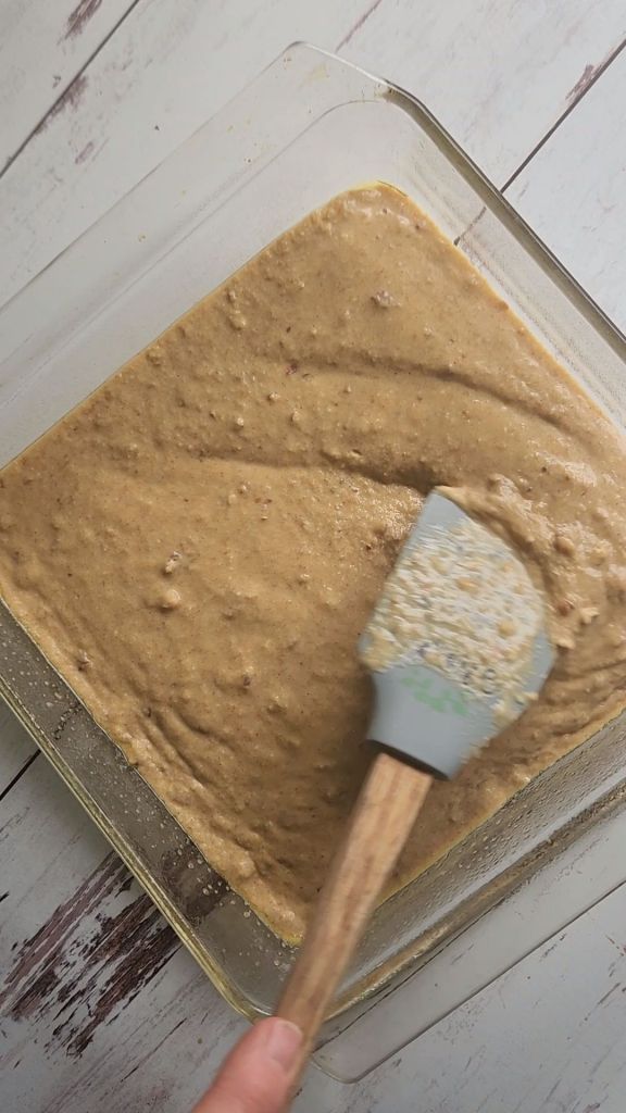 Spreading out better evenly to bake easy gluten-free fluffy baked pecan pancakes.