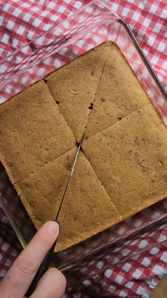 Cutting up easy gluten-free fluffy baked pecan pancake after being baked.